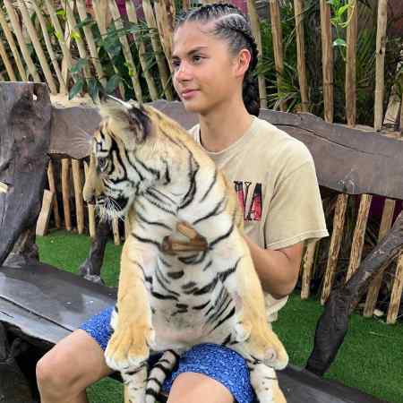 Miguel Cazarez Mora holding a tiger cub.